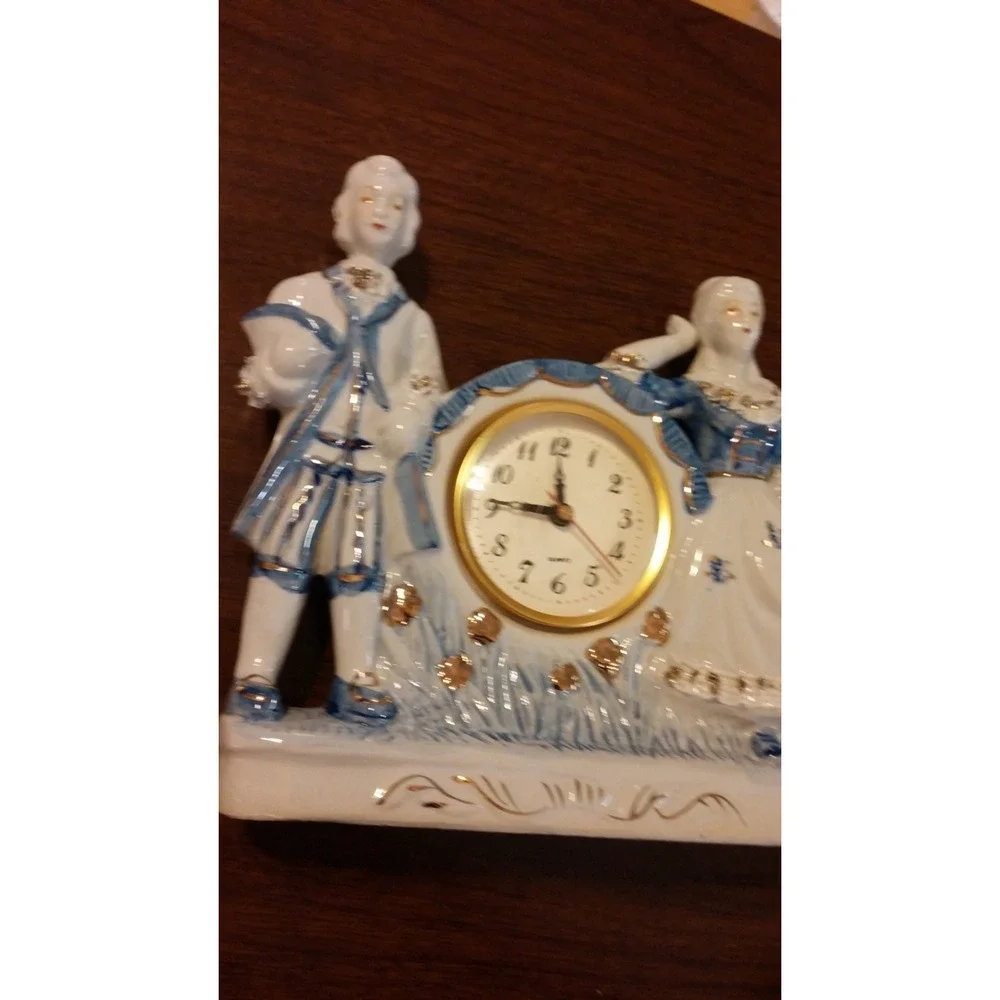 Clock, Porcelain courting couple Delft style statuette clock, blue and white